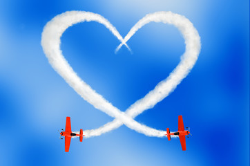 two air-planes drawing a cloudy love is in the air concept