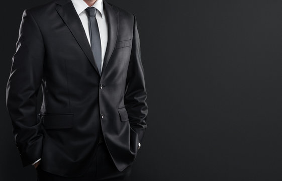 Close up of businessman over dark gray background