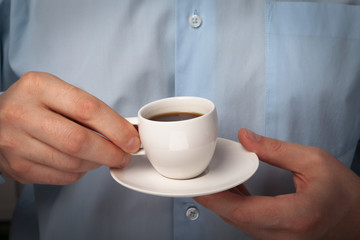 man holding a cup in his hand