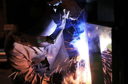 Industrial worker welding steel structure in factory,welding spa