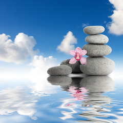 Gray zen stones and orchid sky with clouds