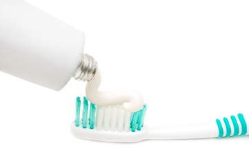 Toothbrush and toothpaste isolated on white background