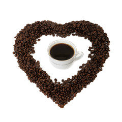 Cup of coffee and coffee beans in the form of heart