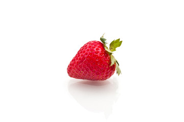 Single Strawberry with leaves isolated on white