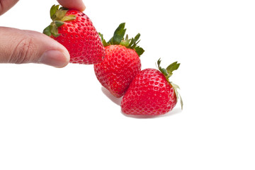 Hand picked strawberry from group, isolated on white
