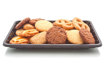 Heap of cookie on black plastic tray, isolated on white