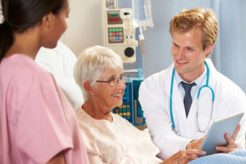 Fototapeta premium Doctor Using Digital Tablet In Consultation With Patient