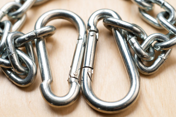Carabiners and Chain on Wooden Table