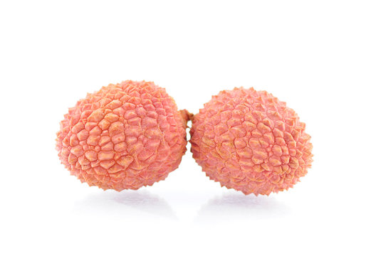 Two lichee fruits on white background
