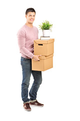 Full length portrait of a young man carrying removal boxes