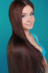 Beautiful woman with long brown hair. Closeup portrait of fashio