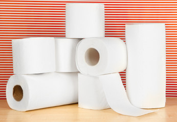 Rolls of toilet paper on striped red background