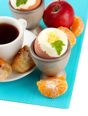 Light breakfast with boiled eggs and cup of coffee, isolated