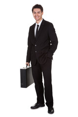 Businessman standing with suitcase