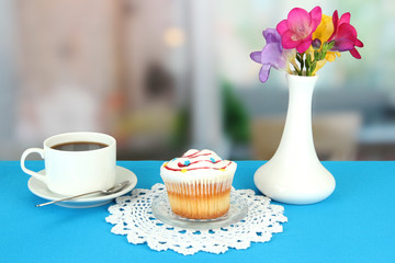 Cupcake on saucer with glass cover, on bright background