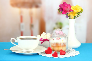 Cupcake on saucer with glass cover, on bright background
