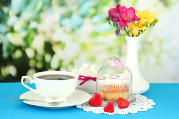 Cupcake on saucer with glass cover, on bright background