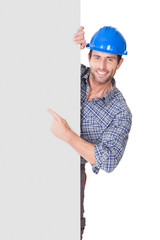 Portrait of happy worker presenting empty banner