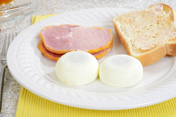 closeup of poached eggs with bacon