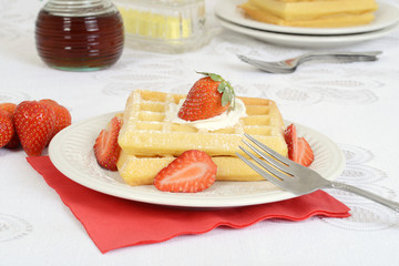 Closeup strawberries whipped cream waffles