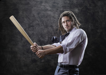 Businessman swinging baseball bat