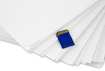 Sd memory card with a stack of printer paper. Hardcopy backup or