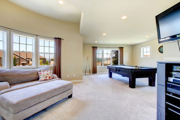Large family room with pool table and tv.