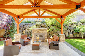 Exterior covered patio with fireplace and furniture. - obrazy, fototapety, plakaty