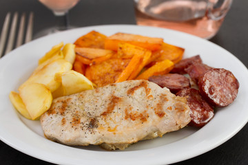 grilled pork with vegetables on the plate