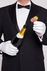 Waiter opening a bottle of champagne