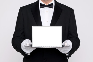 Butler holding a blank card upon a silver tray