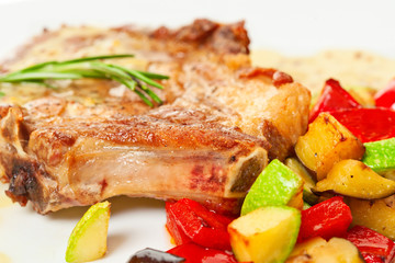 Grilled pork loin with vegetables on the plate