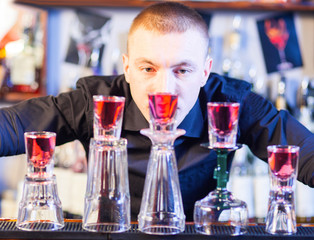barman making cocktail drinks