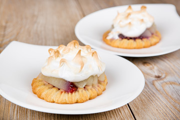 Pear cake stuffed with jam and covered with white meringue