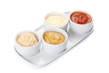 several types of sauce on a white background