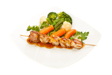 Grilled meat and vegetables on white background