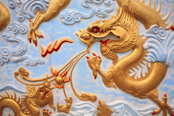 Fototapeta premium Gold dragon craft and painting on Thai temple wall