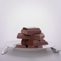 Chocolate bars stack on plate.