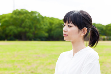 attractive asian woman relaxing in the park