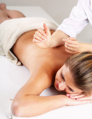 Closeup of an attractive young woman receiving massage