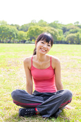 Naklejka na ściany i meble attractive asian woman relaxing in the park