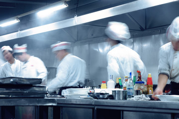 motion chefs of a restaurant kitchen