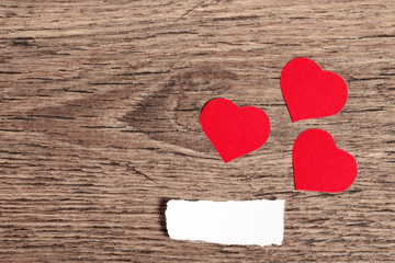 Three red hearts on wood