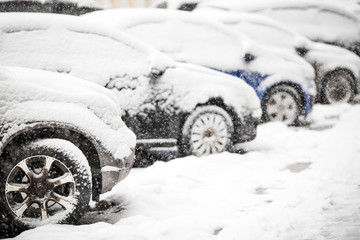 Cars covered with white snow