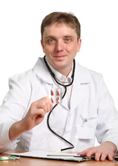 male doctor holding a pill on white