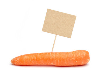Single carrot on white with card on stick