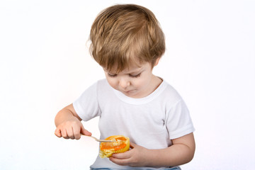 Little boy with eating cheesecake muffin.