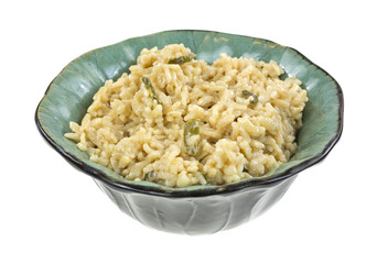 Risotto rice with asparagus in green bowl