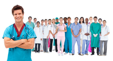 Smiling surgeon in front of a team of doctors standing together