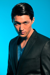 Handsome asian man in suit. Summer fashion. Studio shot.